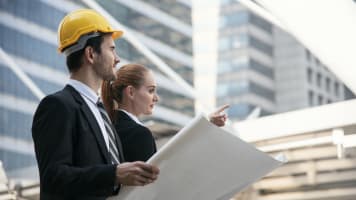 carrier-engineers-looking-at-building-plans