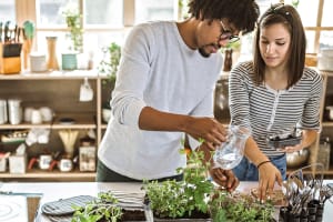 couple-waters-plants-indoors-3x2