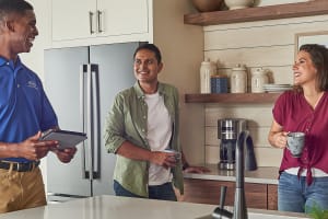 carrier-dealer-discuss-heating-system-with-homeowners-3x2
