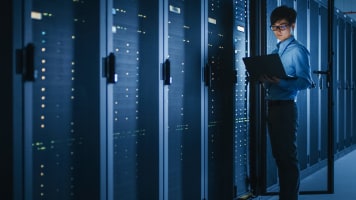 man-in-server-room-with-laptop