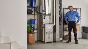 carrier-dealer-in-basement-standing-next-to-a-furnace