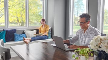 husband-and-wife-in-dinning-room-on-computer-looking-for-hvac-help