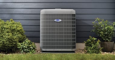 an air conditioner outside of a home as a homeowner ponders how long do air conditioners last