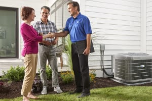 man-shakes-womans-hand-by-air-conditioner