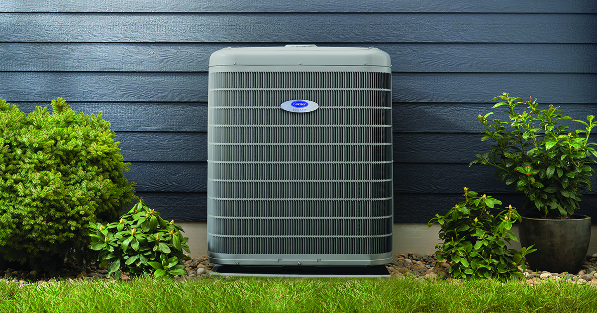 residential air conditioning sits outside a home as a homeowner ponders how long do air conditioners last