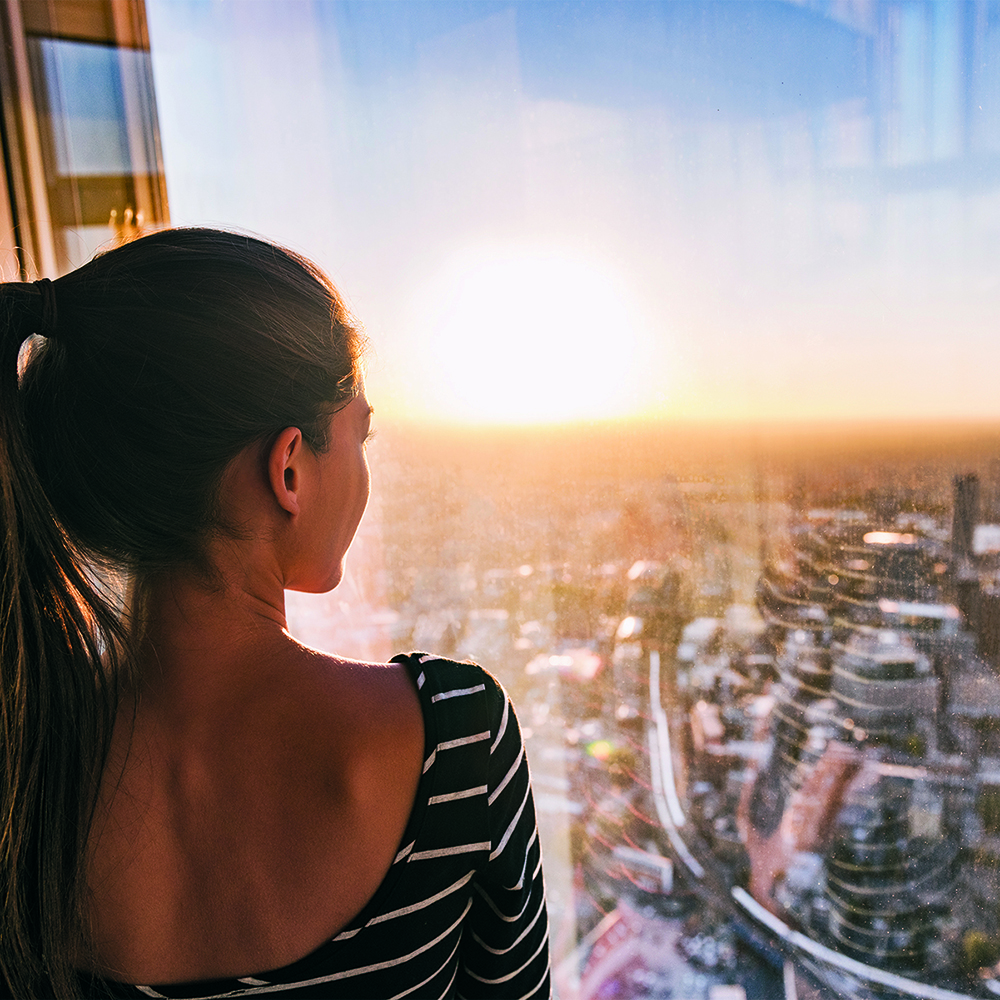 woman-looking-out-hi-rise