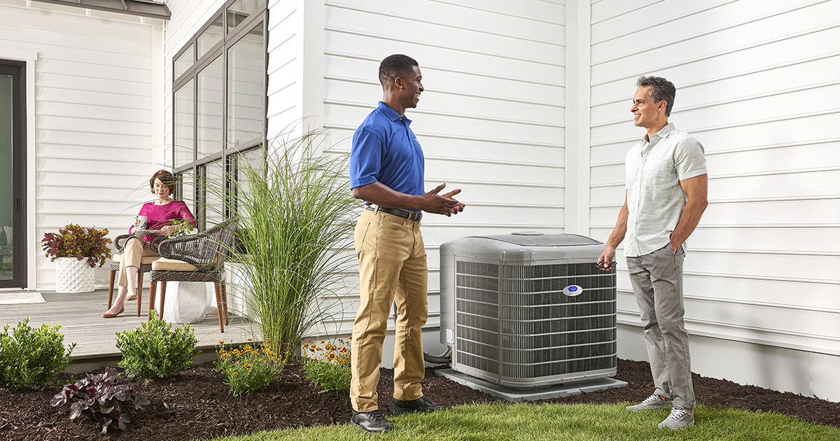 a carrier dealer discusses the benefits of uv lights for air conditioner with a homeowner