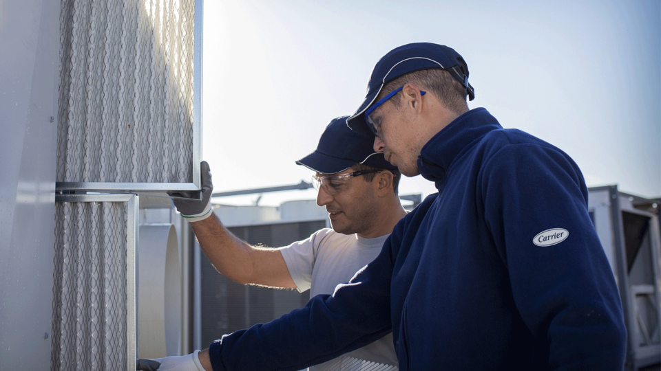 HVAC Equipment Servicing technician performing onsite repairs for Carrier systems