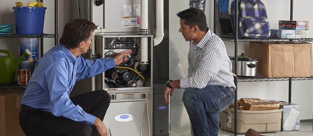 a carrier dealer explains what is a furnace and how does a furnace work to a homeowner