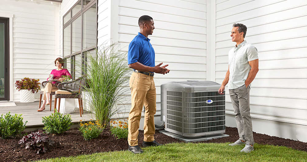 a carrier dealer discusses ac energy efficiency terms with homeowner