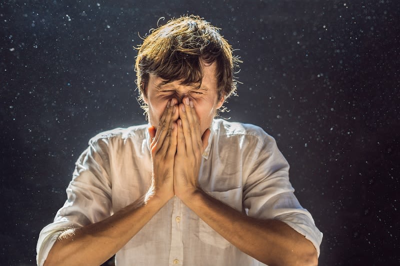 man sneezing indoor air quality