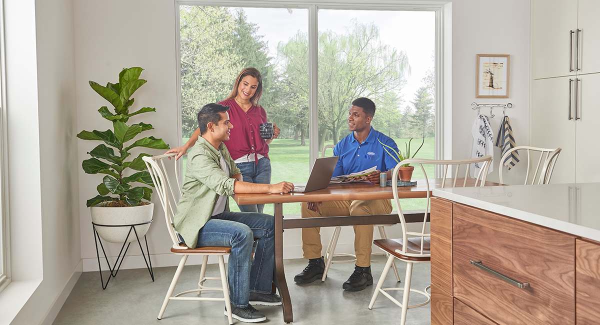 carrier-dealer-discusses-air-conditioning-unit-compressors-with-homeowner