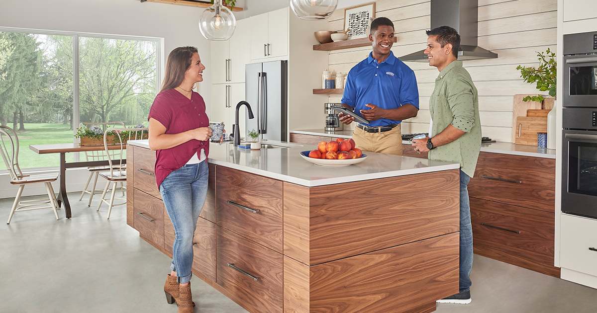 a-carrier-dealer-discusses-hvac-systems-and-types-of-hvac-equipment-with-a-couple