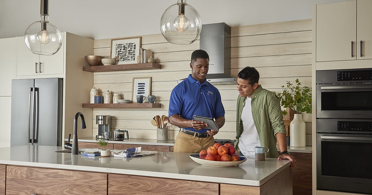 a-carrier-dealer-shows-a-homeowner-hvac-options-for-old-houses