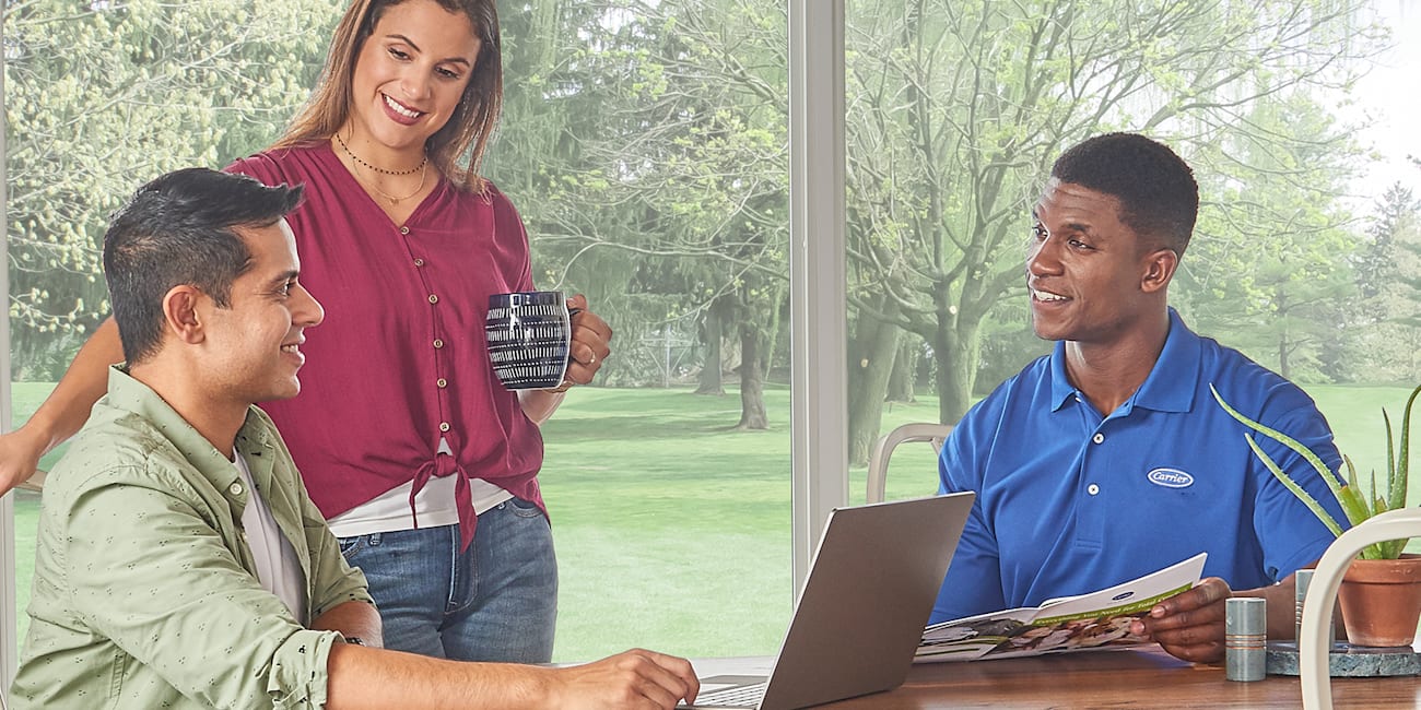 a couple discussing hvac cost with a man from ac company