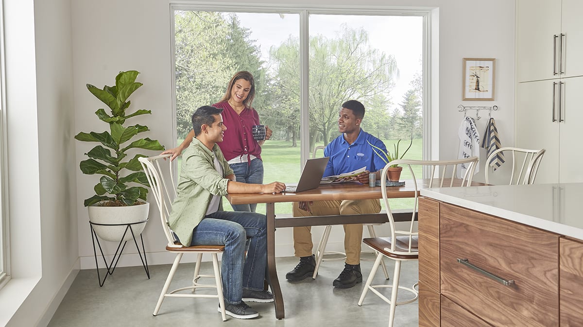 a carrier dealer discusses air conditioner compressor, or ac compressor, options with homeowners