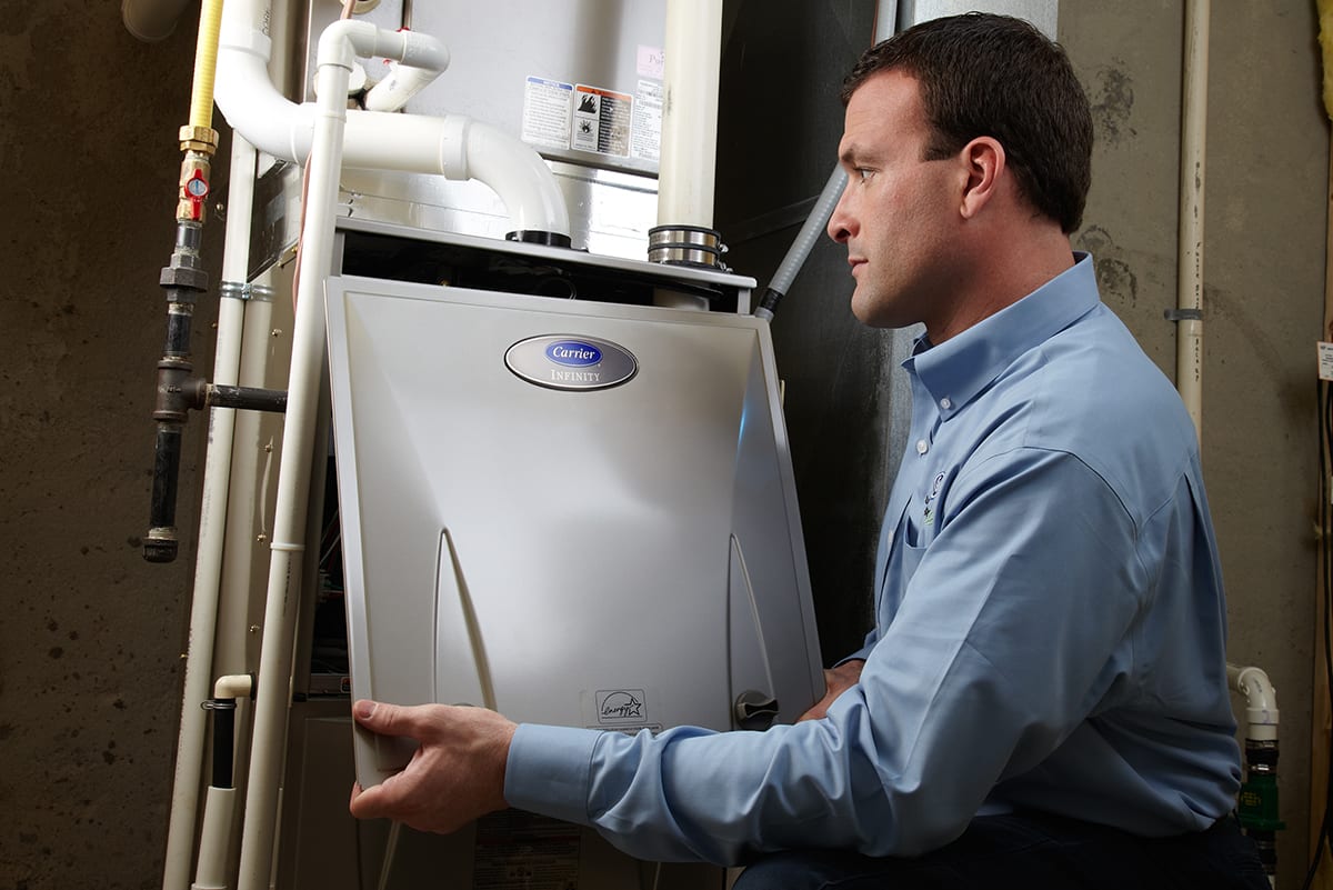 Carrier dealer moving a furnace during a gas furnace replacement