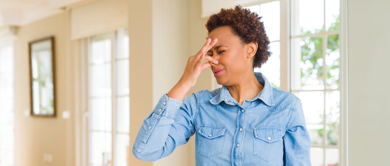 a woman makes a face at burning furnace smell and wonders smelling something burning is a sign of what