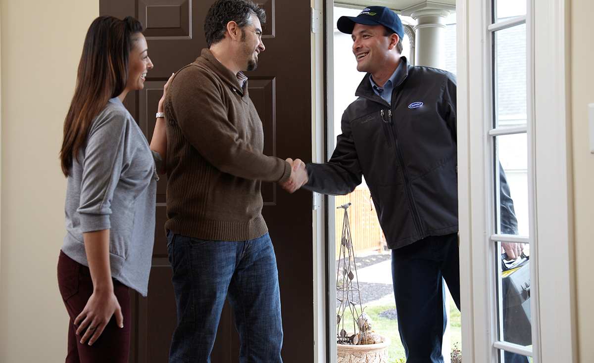 a carrier dealer arrives at a home to investigate a furnace leaking water