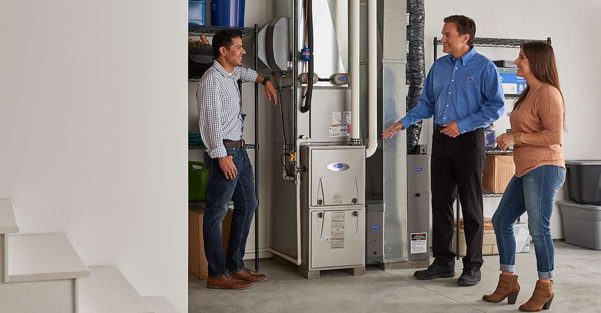 a carrier dealer discusses the value of home ventilation with a couple