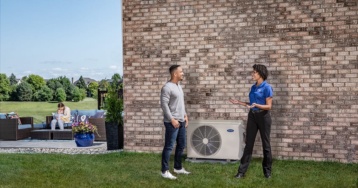 a carrier dealer explains the value of ductless air conditioning to a homeowner