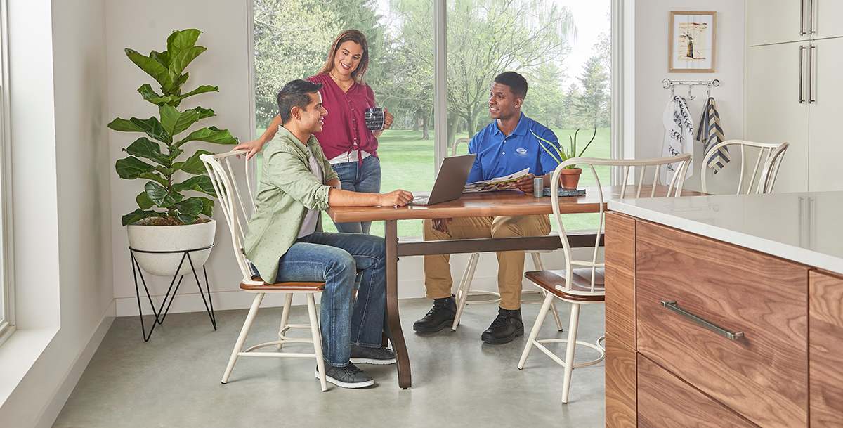 a couple discusses air conditioner filter replacement best practices with a carrier dealer