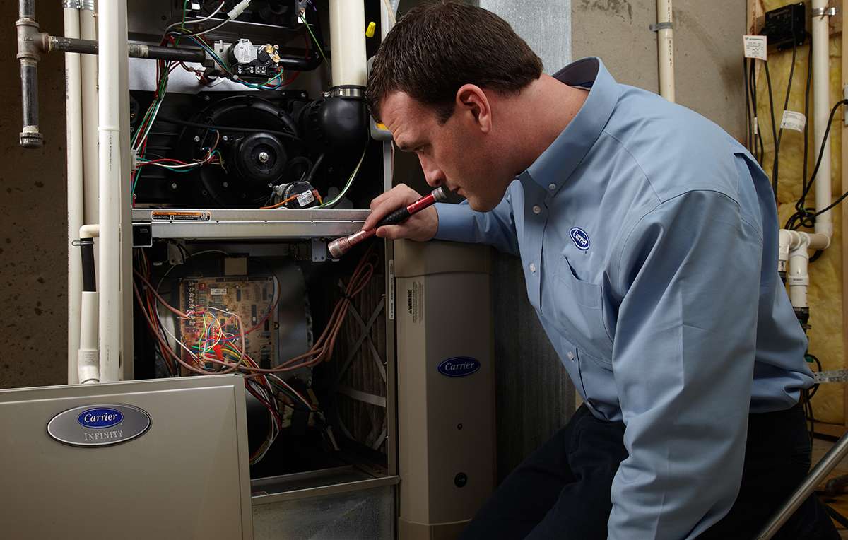 a carrier dealer performs hvac emergency repair on furnace