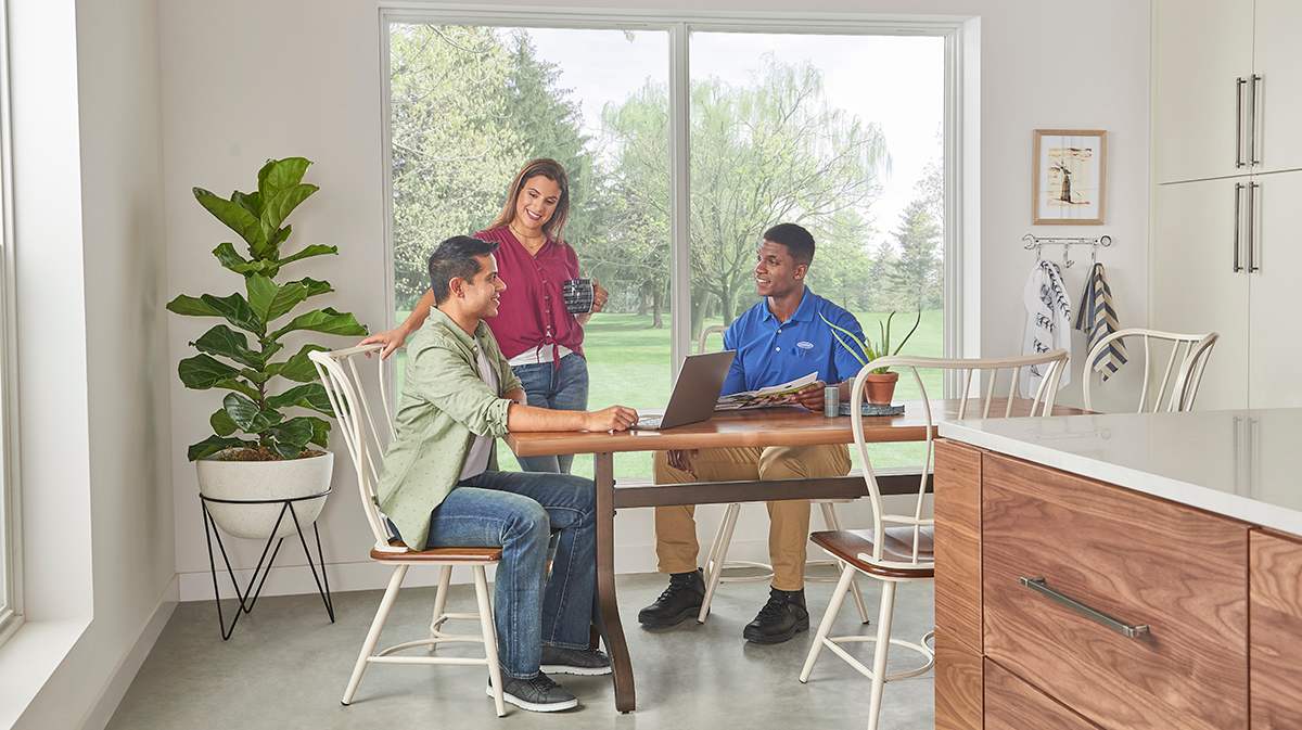 carrier dealer discusses ac compressor cost with homeowners
