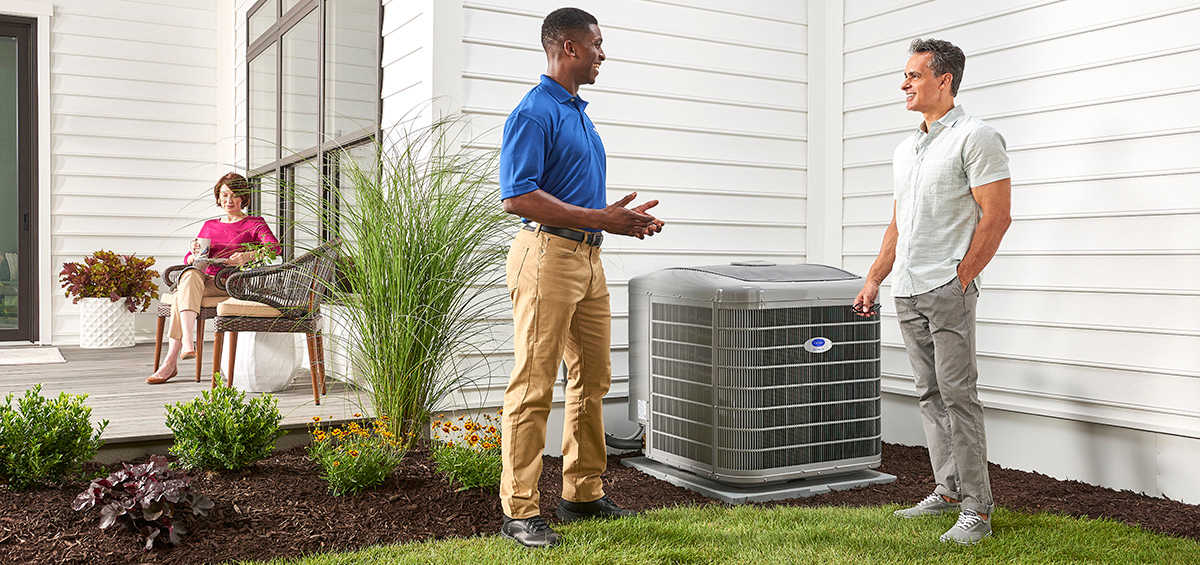 a carrier dealer explains heat pump vs ac with homeowner