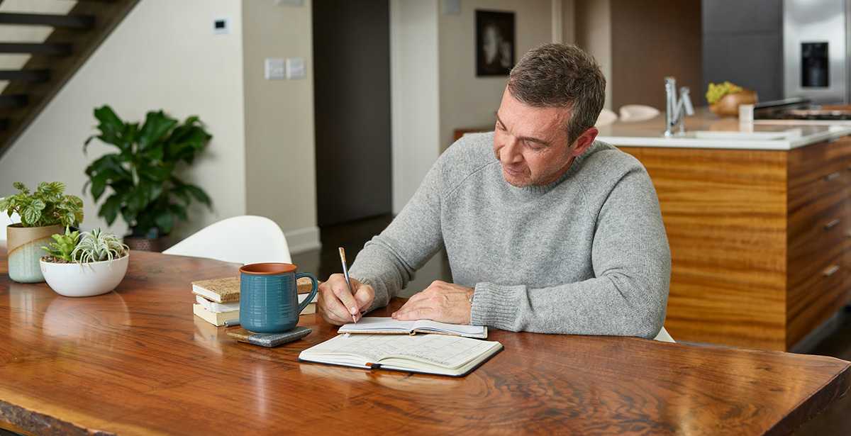 a man writes down plan for carbon monoxide detector chirping