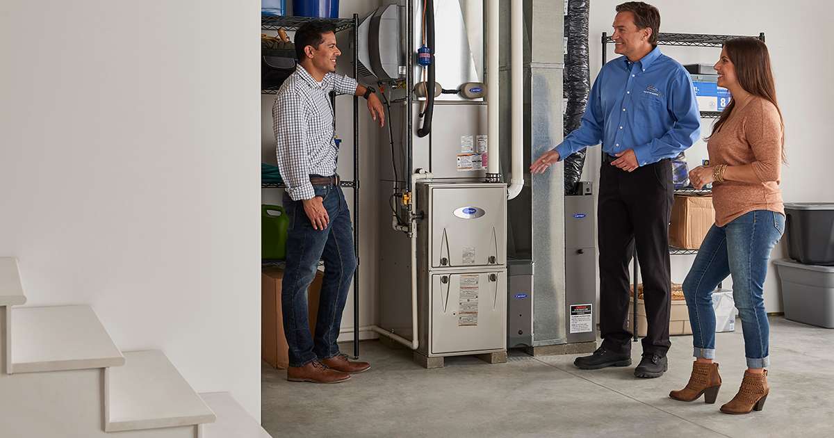 a carrier dealer explains to a couple how long does a furnace last