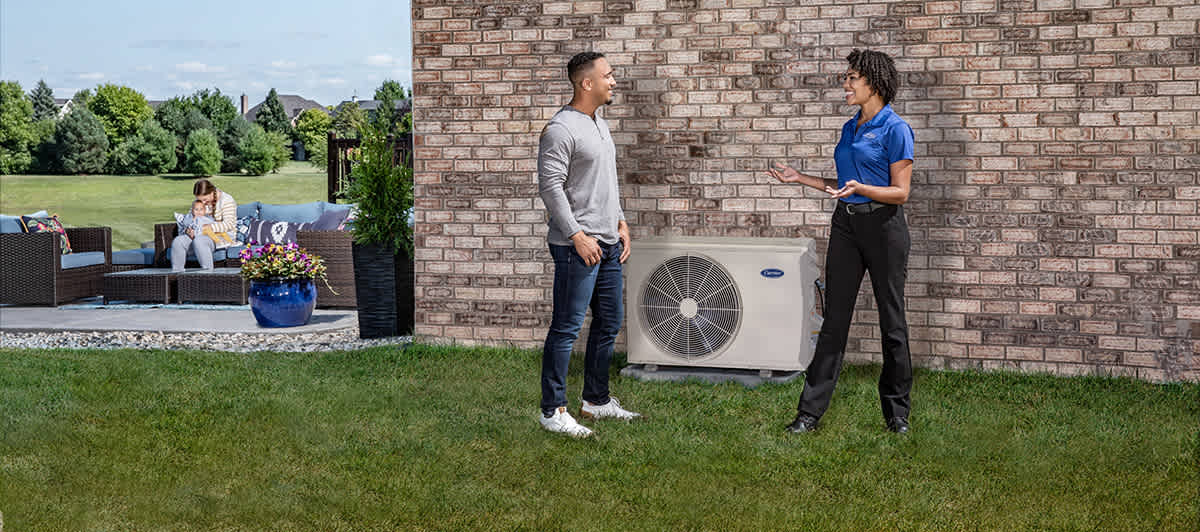 a carrier dealer discusses ductless mini split installation cost with homeowner