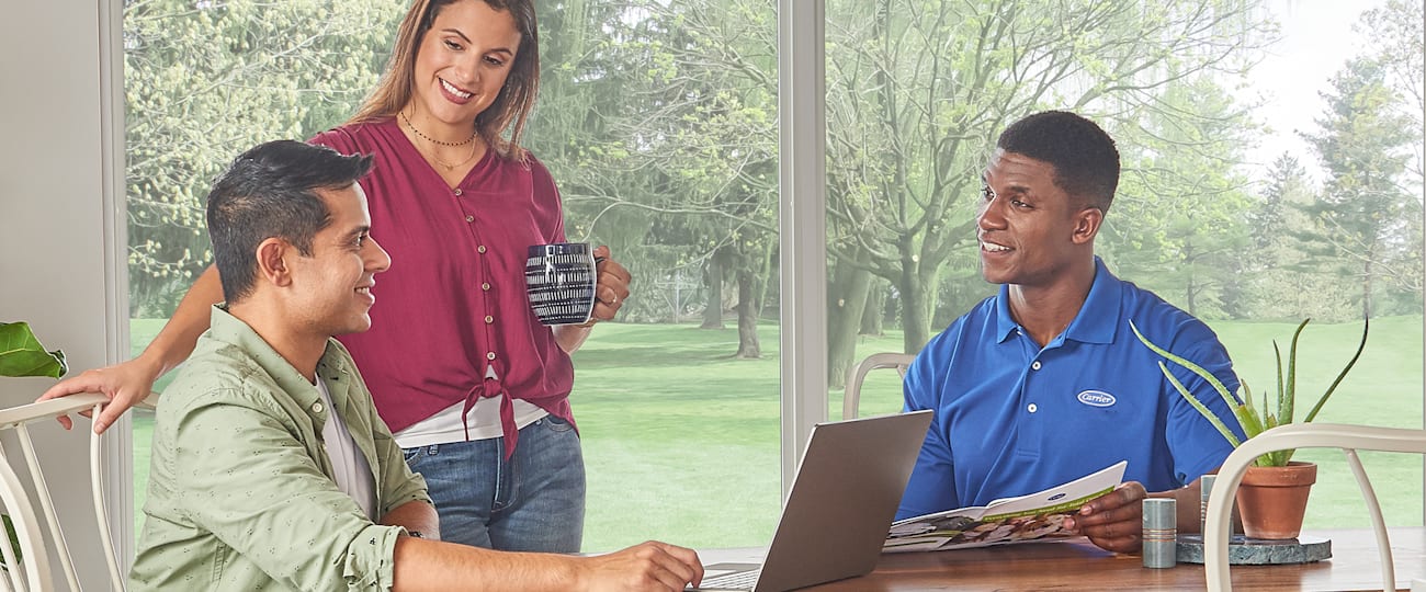 a couple discussing ductless mini split system cost with a dealer