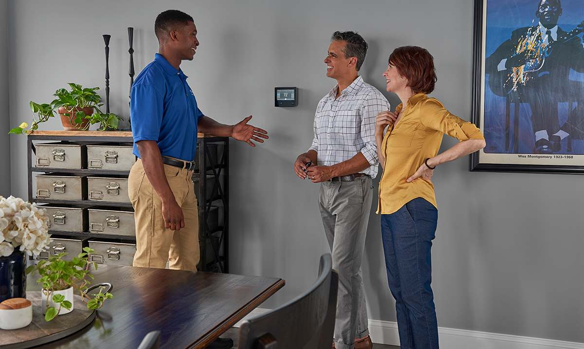 a carrier dealer reviews garage ac unit options with homeowners