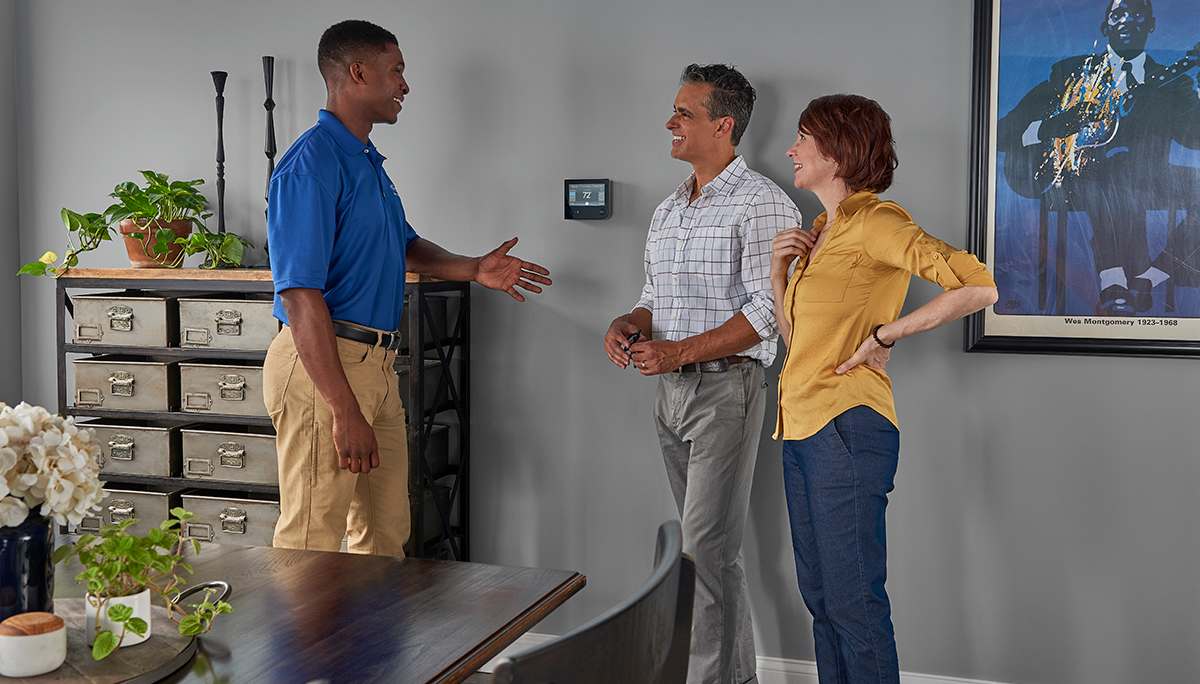a carrier dealer discusses furnace cleaning cost with homeowners