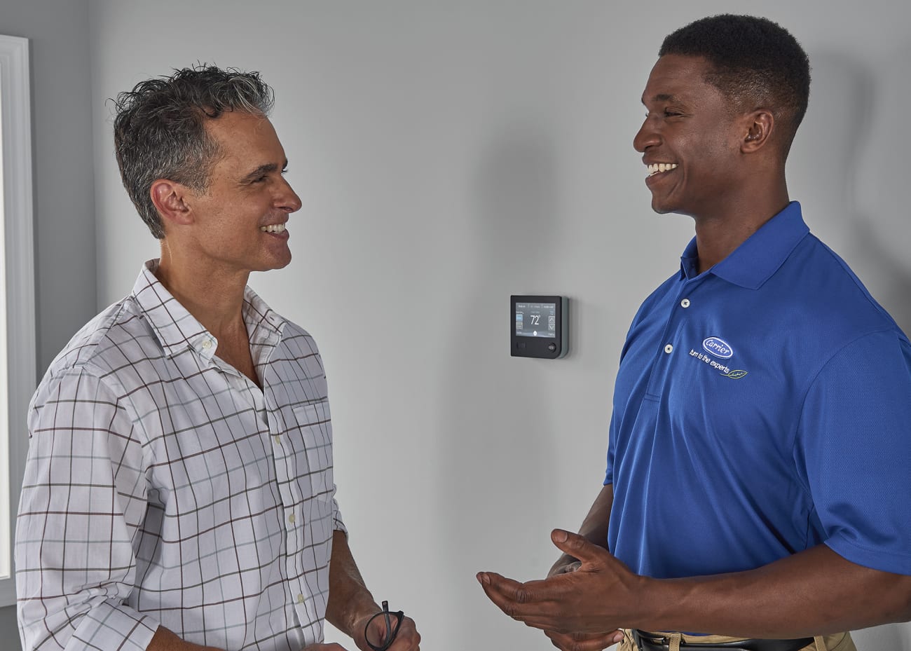 dealer talks to homeowner about carrier infinity wall control