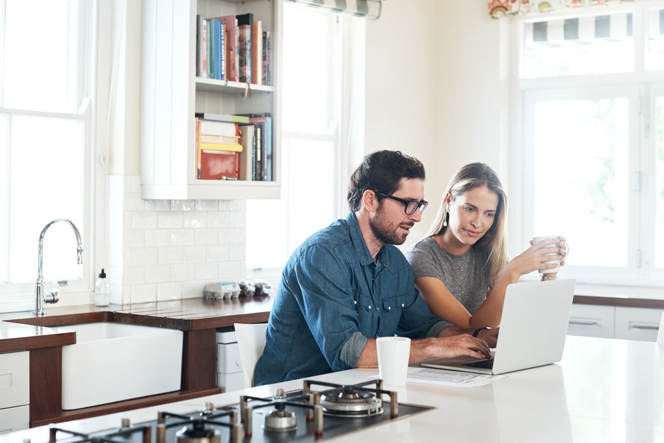 husband-and-wife-in-kitchen-registering-their-hvac-product-online