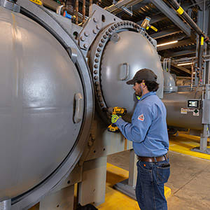 technician-servicing-chiller-with-drill-1x1