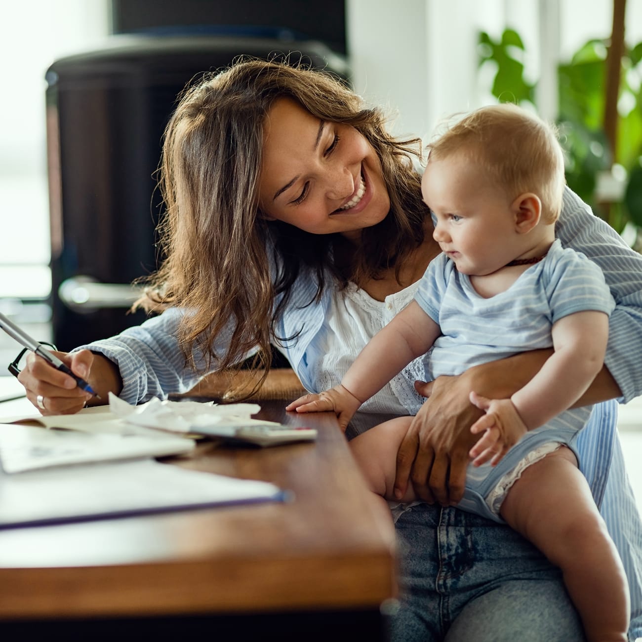 a mom signs up for carrier cool cash with a  baby on her lap