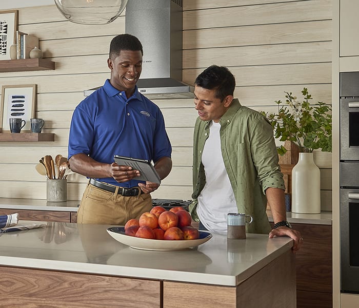carrier-dealer-discussing-ductless-air-conditioner-options-with-a-customer