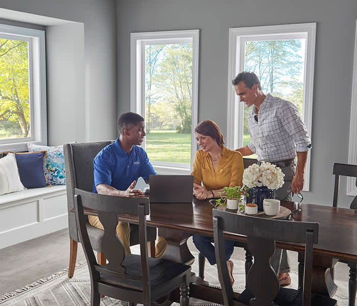 carrier-certified-ductless-pro-talking-to-homewoners-at-table-about-financing-options