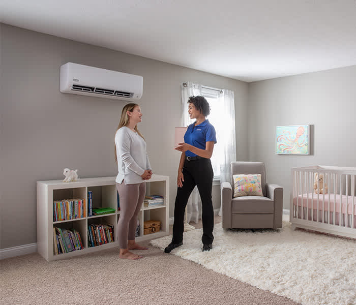 carrier-certified-ductless-pro-talking-to-woman-in-nursery-room