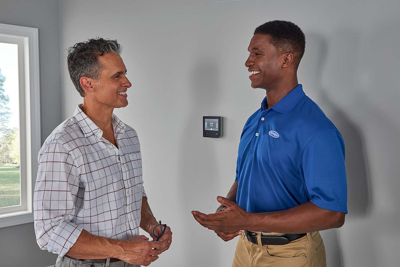 carrier dealer and homeowner discuss best smart thermostat and ac thermostat options