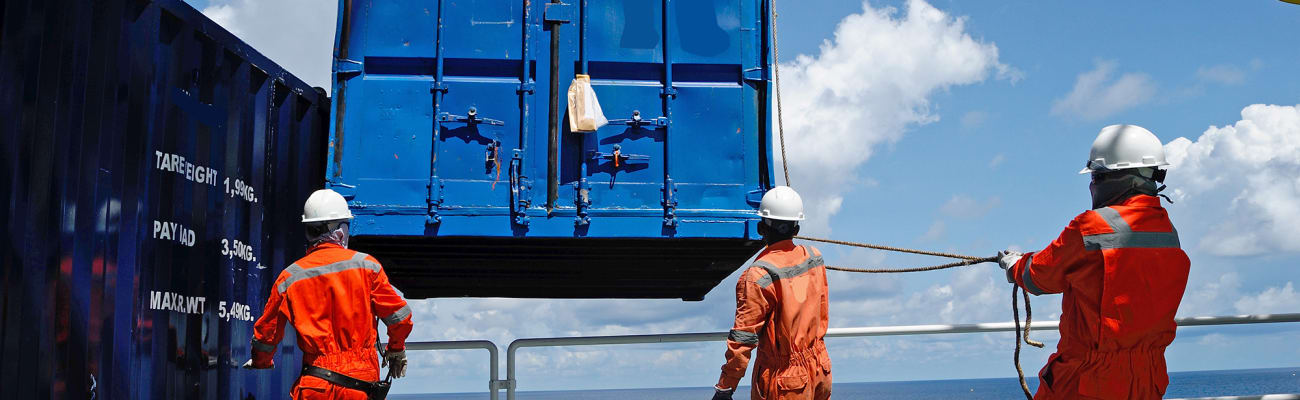 container-ship-workers-moving-container
