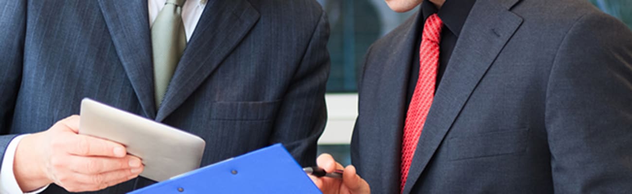 carrier-older-and-younger-professional-men-reviewing-documents-mobile