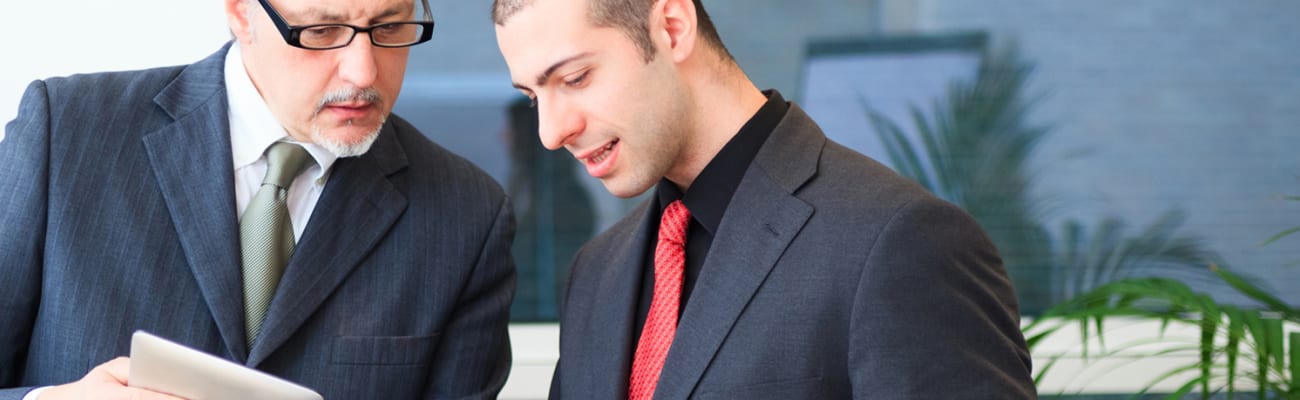 carrier-older-and-younger-professional-men-reviewing-documents-sm