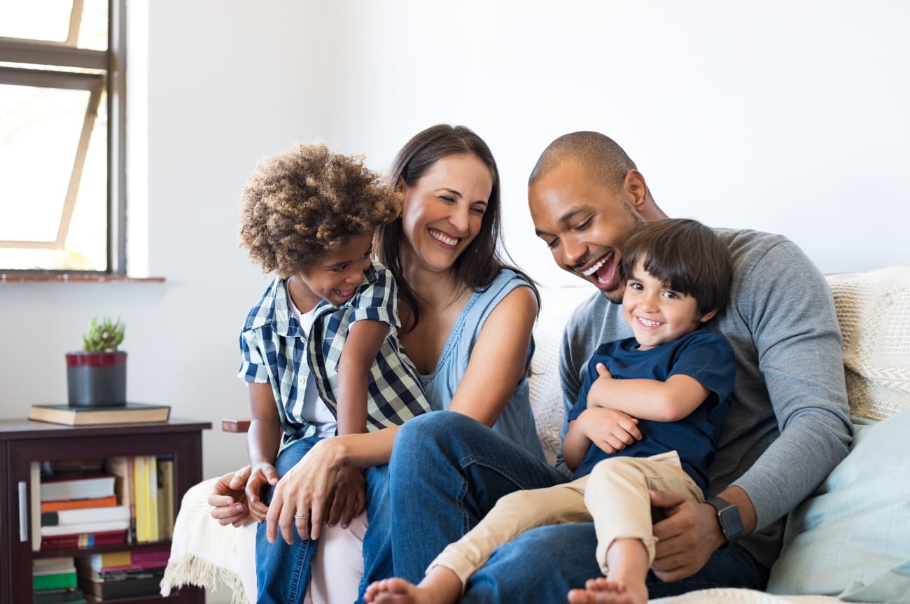 Mom_and_Dad_with_Two_Boys_Sitting_on_Sofa
