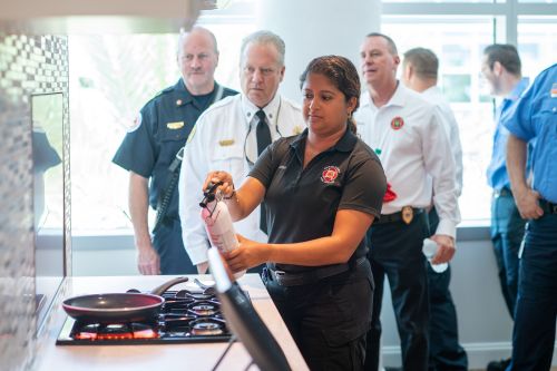 _TW53473 Tour attendees use our Kidde fire extinguisher to respond to a simulated kitchen fire.
