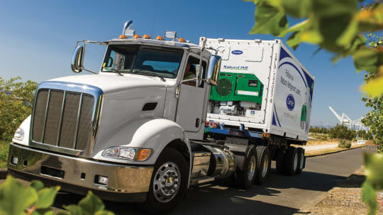 Carrier refrigeration truck driving on road.