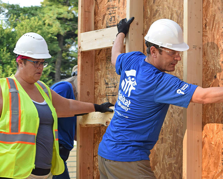 employee volunteers building walls